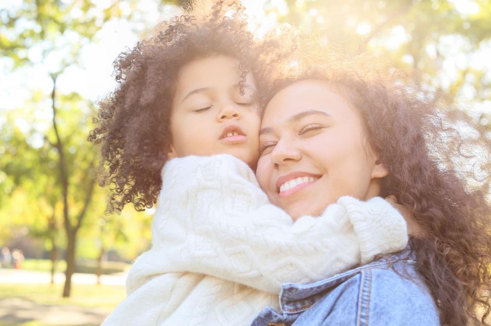 https://freerangestock.com/photos/164415/mom-embracing-daughter-in-sunlit-park.html